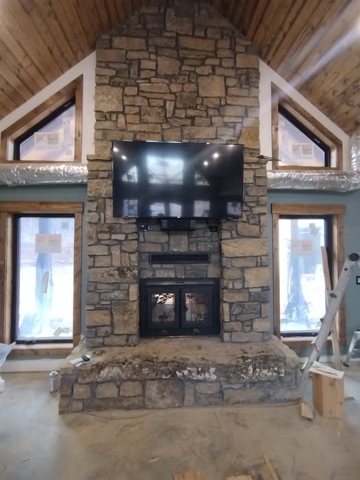 Stone fireplace crafted by Russellville Masonry
